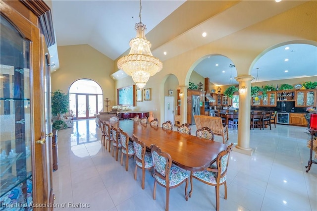 14630 Luray Rd, Southwest Ranches, FL 33330 - dining space featuring arched walkways, decorative columns, light tile patterned flooring, wine cooler, and lofted ceiling