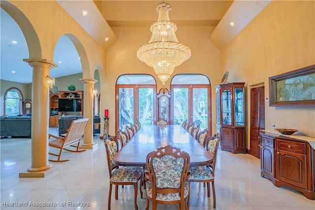 14630 Luray Rd, Southwest Ranches, FL 33330 - dining space featuring arched walkways, ornate columns, recessed lighting, a high ceiling, and light tile patterned flooring