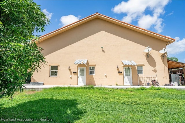 14630 Luray Rd, Southwest Ranches, FL 33330 - back of house featuring stucco siding and a yard