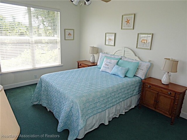 bedroom with ceiling fan and dark colored carpet