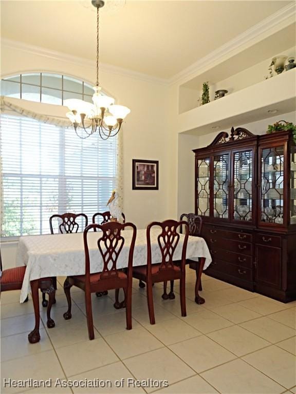 dining space featuring crown molding, light tile patterned flooring, and a chandelier