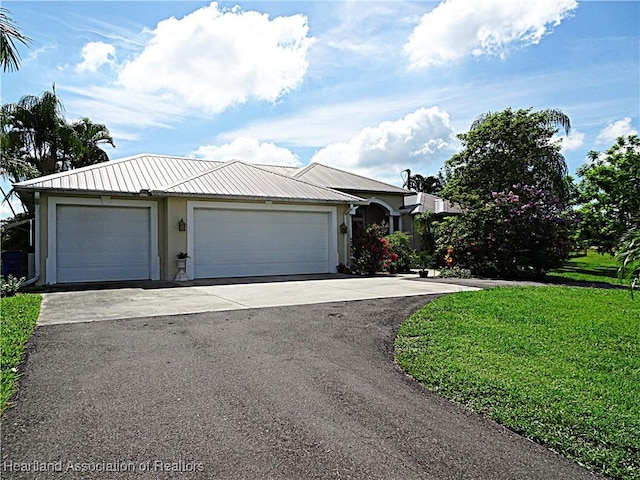 view of front of property with a front lawn and a garage