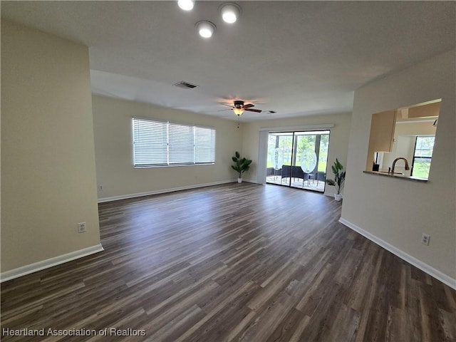 2713 Par Rd, Sebring, FL 33872 - unfurnished living room with dark wood-style flooring and ceiling fan