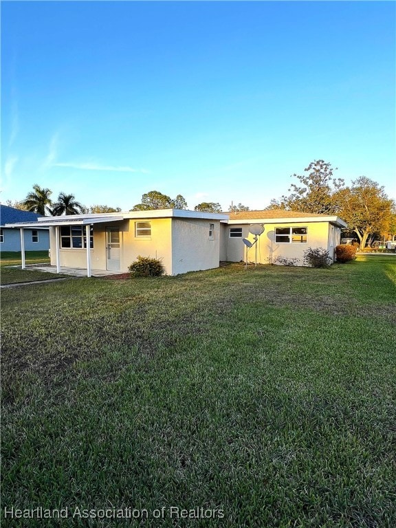 ranch-style home with a front lawn