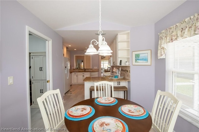 dining space with a healthy amount of sunlight and lofted ceiling