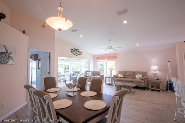 dining area with ceiling fan, high vaulted ceiling, and light wood-type flooring