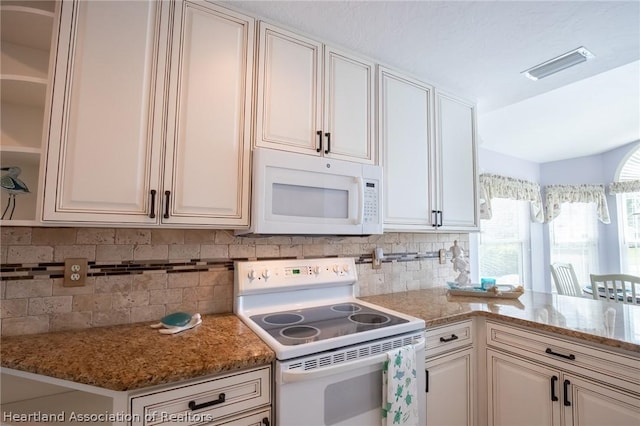 kitchen with stone countertops, white cabinetry, white appliances, and backsplash