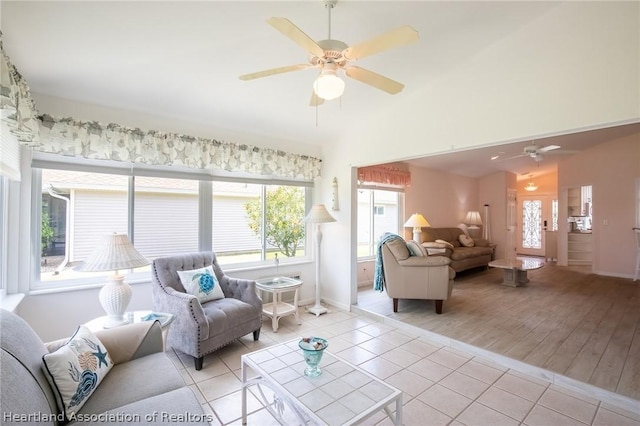 tiled living room with ceiling fan