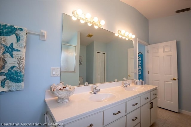 bathroom featuring tile patterned flooring, vanity, and toilet