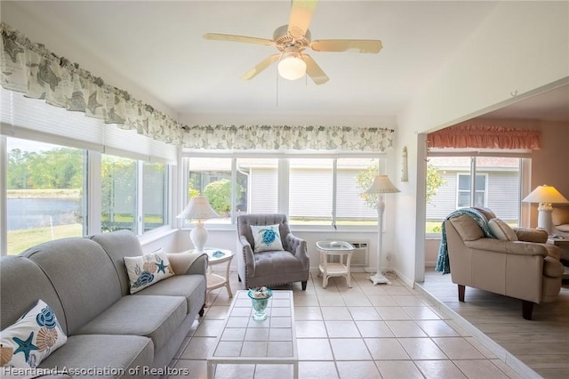 sunroom with a wall mounted AC and ceiling fan