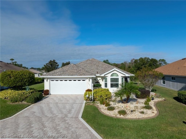 ranch-style house featuring a garage and a front lawn