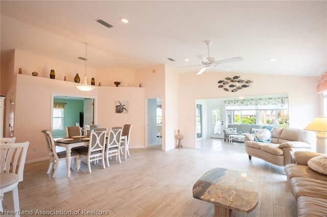 living room featuring light wood-type flooring, high vaulted ceiling, and ceiling fan