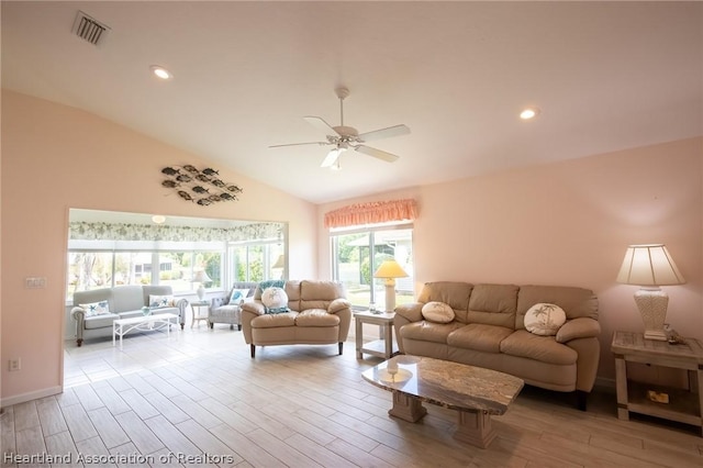 living room featuring ceiling fan and vaulted ceiling