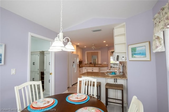 dining area with ceiling fan and lofted ceiling