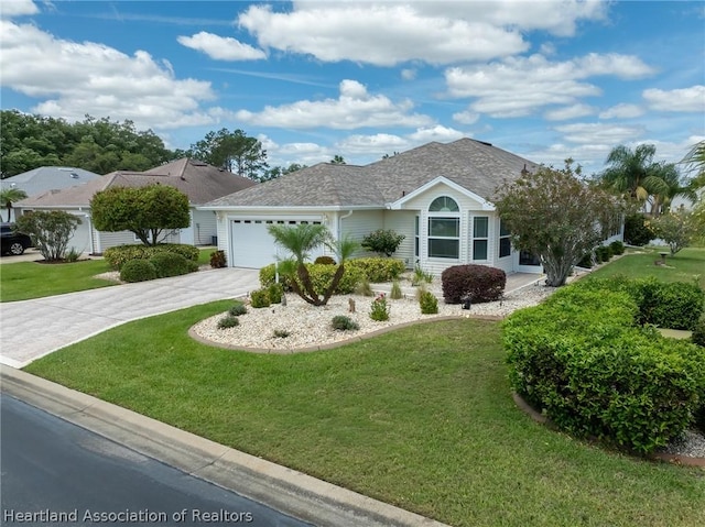 ranch-style home featuring a front yard and a garage