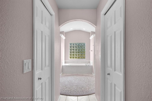 hallway featuring vaulted ceiling