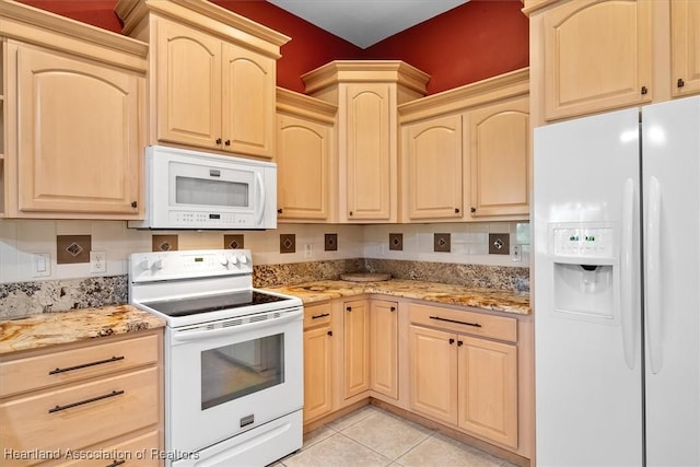 kitchen with light stone countertops, light brown cabinetry, white appliances, and light tile patterned flooring