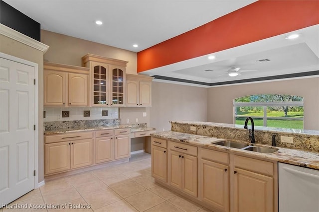 kitchen featuring light brown cabinets, stainless steel dishwasher, ceiling fan, and sink