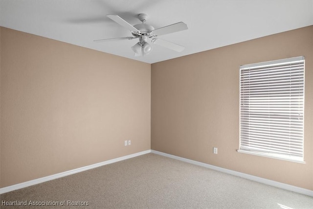 spare room with carpet flooring and ceiling fan