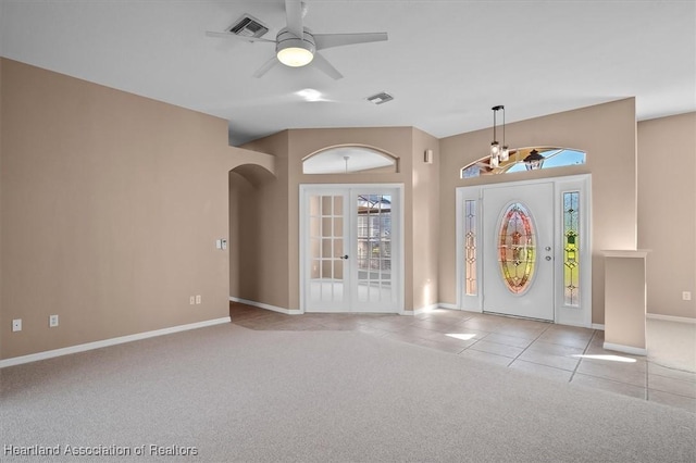 foyer with ceiling fan, light tile patterned flooring, and french doors