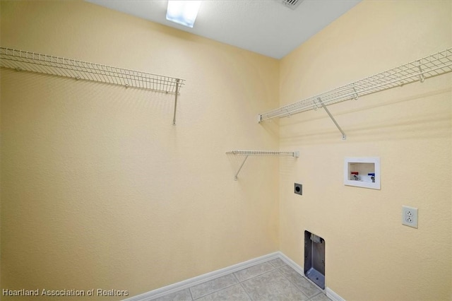 laundry area with washer hookup, electric dryer hookup, and light tile patterned floors