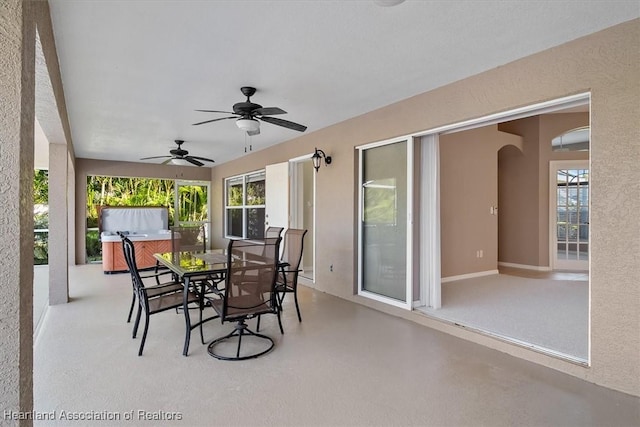 view of patio / terrace with ceiling fan and a hot tub