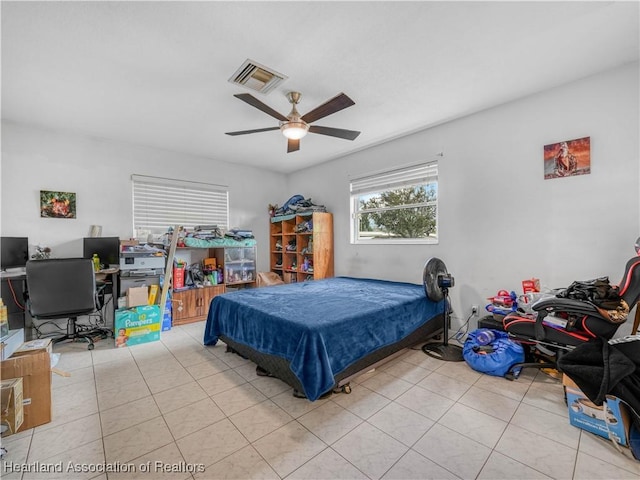 tiled bedroom featuring visible vents and a ceiling fan