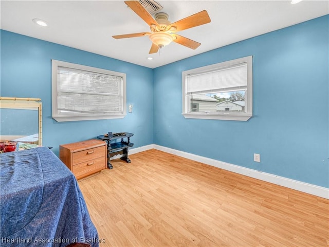 bedroom featuring ceiling fan, recessed lighting, wood finished floors, visible vents, and baseboards