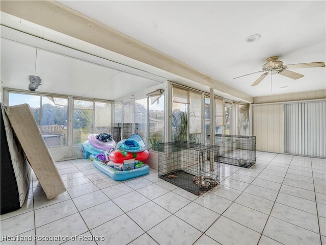 unfurnished sunroom featuring a ceiling fan