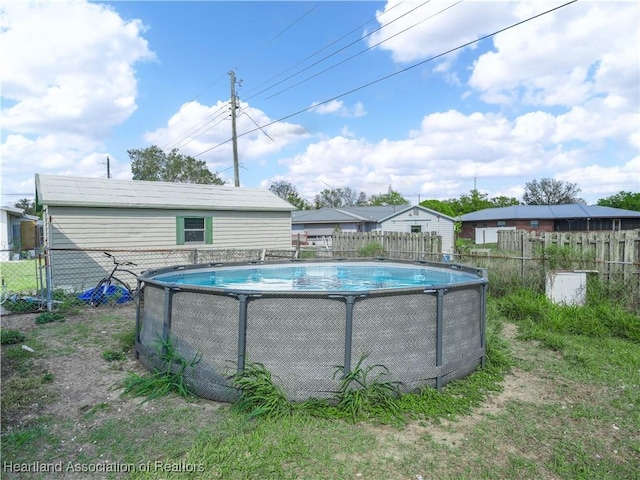 view of swimming pool with a fenced in pool and fence