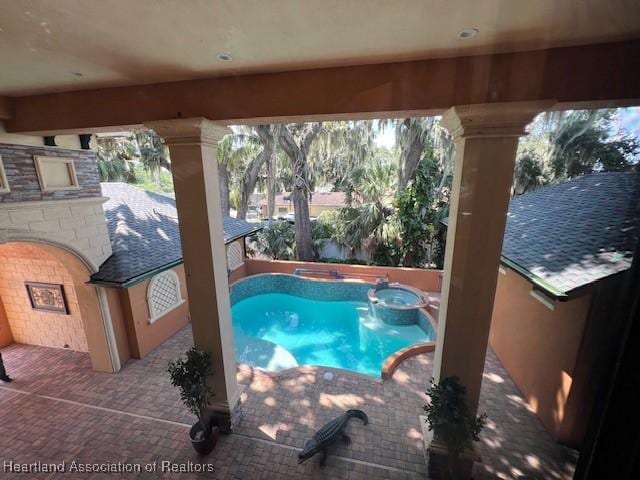 2230 Lake Ariana Blvd, Auburndale, FL 33823 - view of swimming pool featuring a pool with connected hot tub and a patio