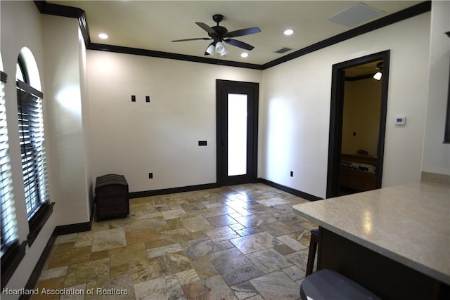 2230 Lake Ariana Blvd, Auburndale, FL 33823 - entryway with plenty of natural light, ceiling fan, stone tile flooring, and ornamental molding