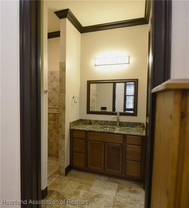 2230 Lake Ariana Blvd, Auburndale, FL 33823 - full bathroom featuring crown molding, vanity, and tiled shower