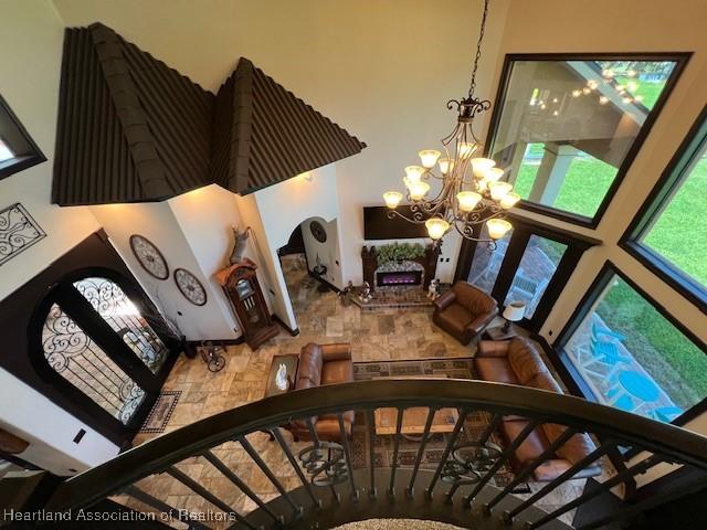 2230 Lake Ariana Blvd, Auburndale, FL 33823 - stairs with a towering ceiling and a chandelier