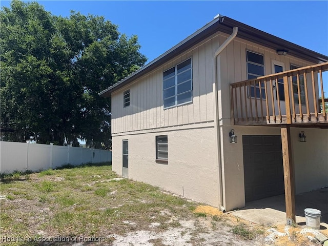 view of side of home featuring fence