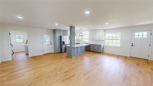397 Maude Rd, Wauchula, FL 33873 - kitchen featuring a wealth of natural light, gray cabinetry, a center island, and appliances with stainless steel finishes