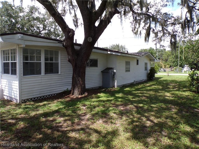 rear view of house featuring a yard