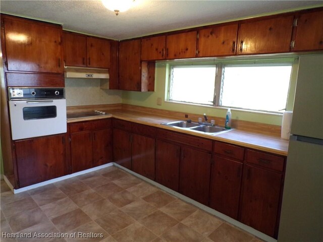 kitchen featuring sink and white appliances