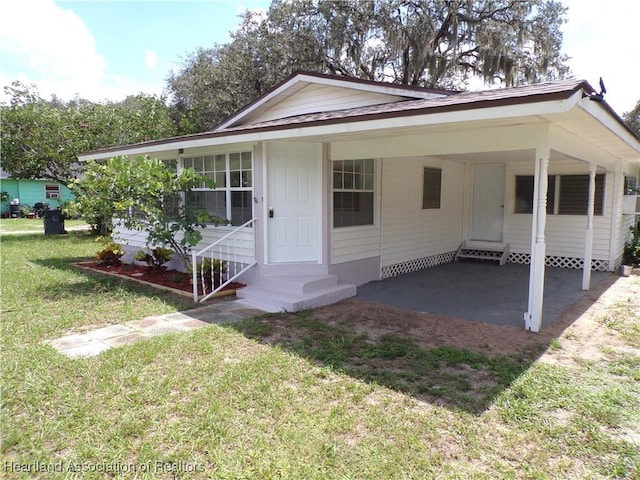 view of front facade with a front lawn and a carport