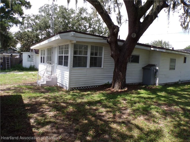 rear view of house featuring a lawn