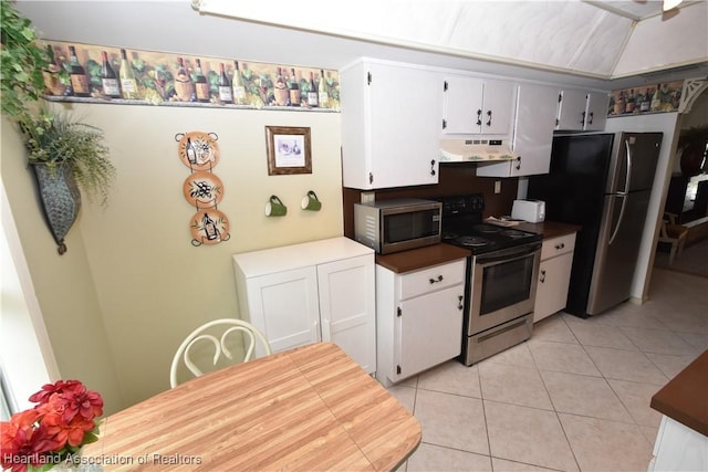 kitchen featuring appliances with stainless steel finishes, white cabinetry, and light tile patterned floors