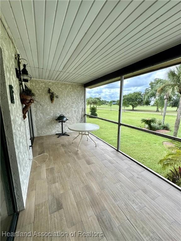 unfurnished sunroom with wooden ceiling