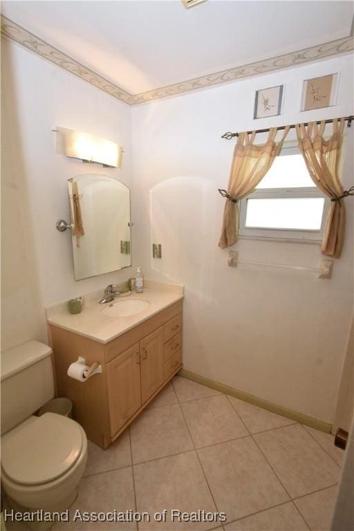 bathroom featuring toilet, vanity, and tile patterned floors