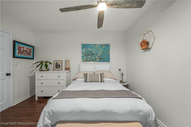 bedroom with ceiling fan and dark wood-style flooring