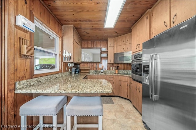 kitchen with stainless steel appliances, wooden ceiling, a peninsula, and light stone countertops