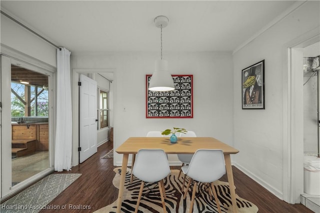 dining area featuring dark wood-style floors and baseboards