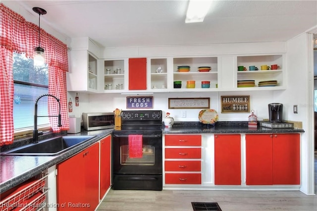 119 Mini Rd, Sebring, FL 33870 - kitchen with red cabinets, black range with electric cooktop, open shelves, and light wood finished floors