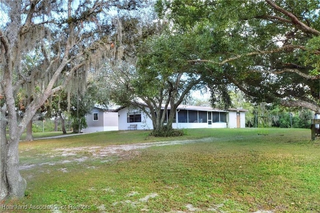 119 Mini Rd, Sebring, FL 33870 - ranch-style house with a sunroom and a front yard