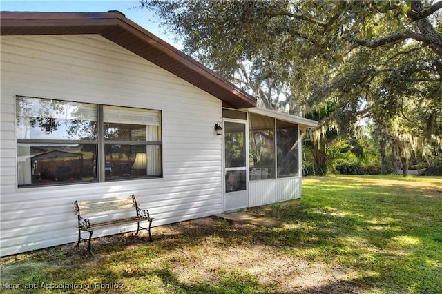 119 Mini Rd, Sebring, FL 33870 - view of side of home with a yard and a sunroom