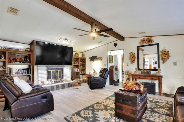 119 Mini Rd, Sebring, FL 33870 - living area featuring a brick fireplace, a ceiling fan, and wood finished floors